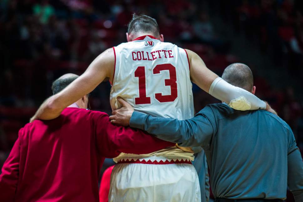Chris Detrick  |  The Salt Lake Tribune
Utah Utes forward David Collette (13) is helped off of the court after falling during the game at the Huntsman Center Saturday March 4, 2017.