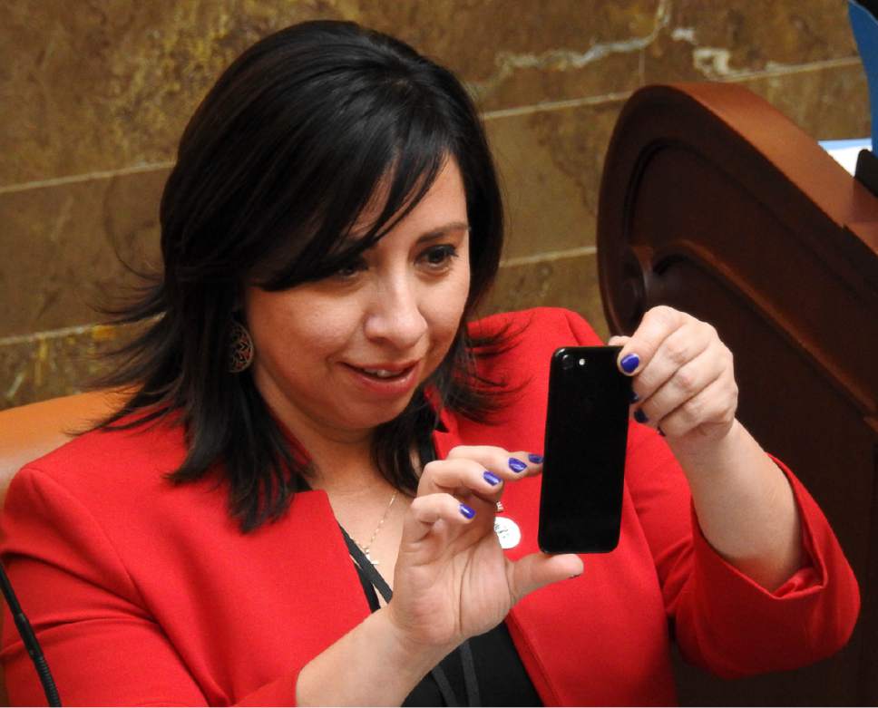 Trent Nelson  |  The Salt Lake Tribune
Rep. Angela Romero, D-Salt Lake, takes a photo as the Utah House debates and passes SB159, which requires motorcyclists under 21 to wear a helmet, Wednesday March 8, 2017 in Salt Lake City.