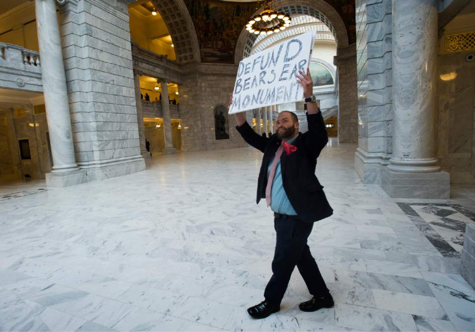 Rick Egan  |  The Salt Lake Tribune

Kern Huerta, West Valley, Raises one of his signs as he walks around the Utah State Capitol Rotunda, during the legislative session,Tuesday, March 7, 2017.