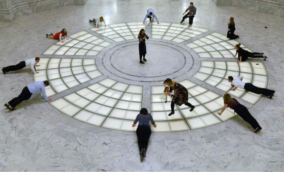 Leah Hogsten  |  The Salt Lake Tribune
After the Utah House legislators ended the day, the House interns took to the rotunda for a workout. Intern Ashley Edwards pretended to bark orders through a megaphone while Aundrea Peterson filmed the crew with her camera. The sweat was all in fun for the annual House intern video shown every year on the last day of the legislative session.