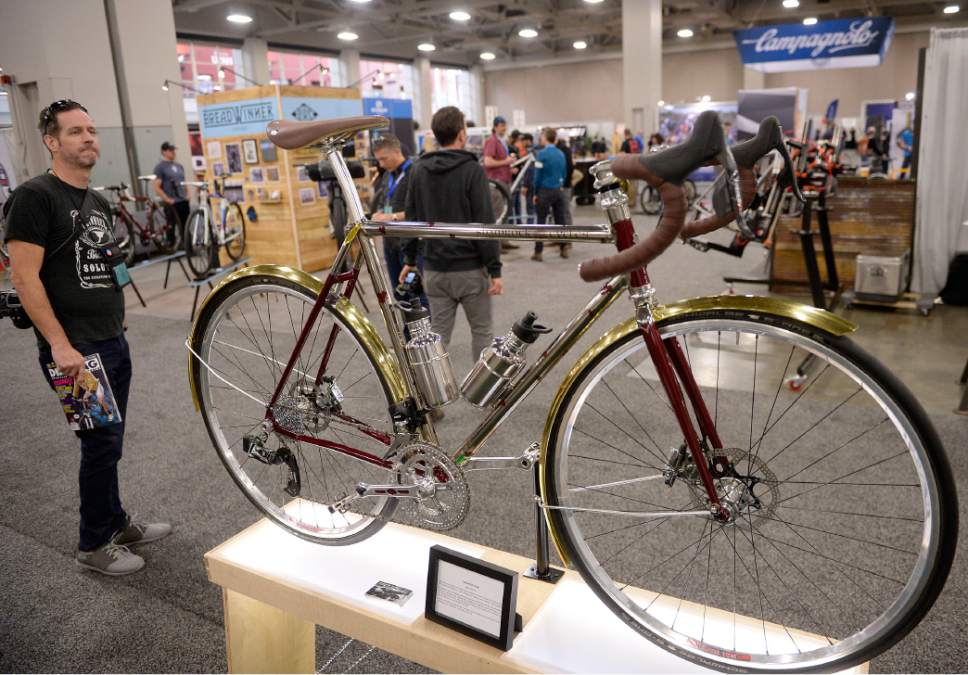 Al Hartmann  |  The Salt Lake Tribune
Bike enthusiast admires a handmade Shamrock bicycle at the 2017 North American Handmade Bicycle Show at the Salt Palace Convention Center Friday March 10.  Shamrock Cycles are made in Indiana.   They are low maintenance and have an old world feel using polished lugs and tubes, single color paint and leather parts. 
It's the largest and oldest handbuilt bicycle show in the world where ideas and innovation come together to promote custom bicycles and the companies that support the market.  It's the show's first time in Utah. The event runs Friday, March 10, to Sunday, March 12.
