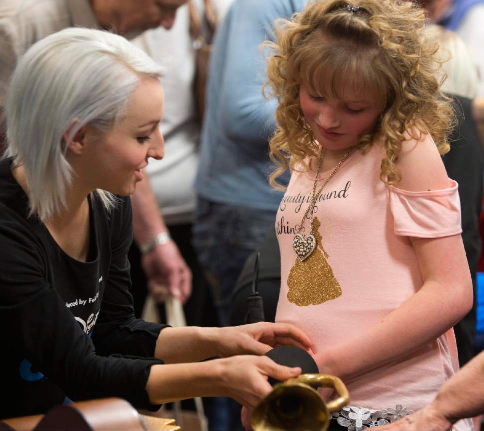 Rick Egan  |  The Salt Lake Tribune

Stacy Craik a skater from Disney On Ice,  helps Kiyrah Miller touch some of the props from the show, during a Special Sensory Touch Tour for Visually-Impaired Students from Utah Schools for the Deaf and Blind at Vivint Smart Home Arena, Friday, March 10, 2017.