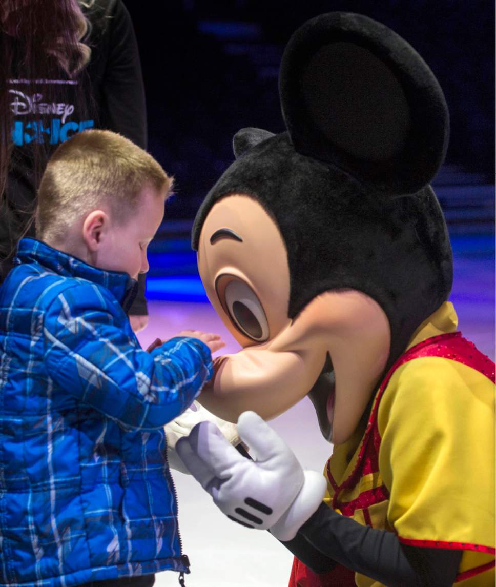 Rick Egan  |  The Salt Lake Tribune

Stacy Craik assists  5-year-old Alessa, as she touches Mickey Mouse, during a special sensory touch tour for visually-impaired students from Utah Schools for the Deaf and Blind, hosted by Disney On Ice, at Vivint Smart Home Arena, Friday, March 10, 2017.