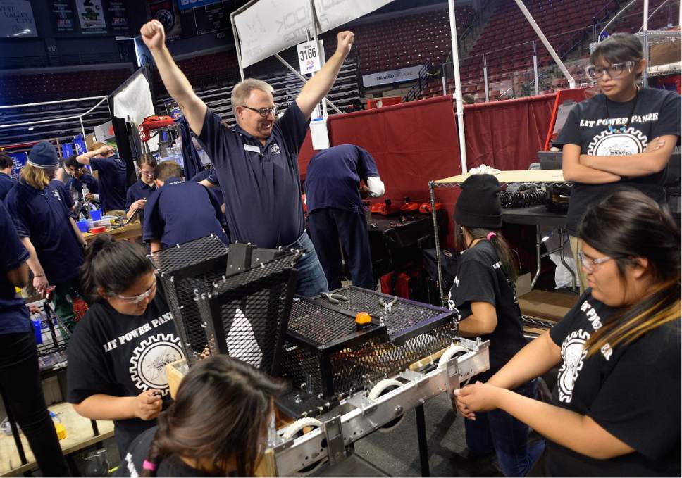 Scott Sommerdorf | The Salt Lake Tribune
Waterford's mentor Lewis Williams looks over from the Waterford workspace next door to the Navajo Mountain High School robotics team and celebrates their success in removing a stubborn bumper. The Navajo Mountain Jaguars compete at the "Utah FIRST Robotics Competition," Thursday, March 9, 2017.