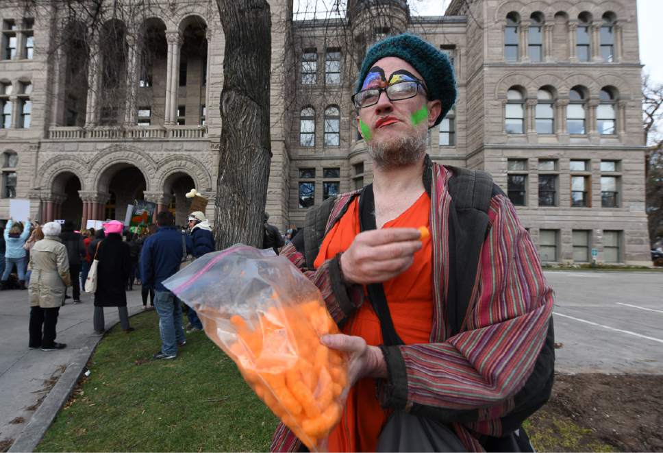 Francisco Kjolseth | The Salt Lake Tribune
Owen Edwards eats Cheeto's as he joins protesters gathered at the City and County Building on President's Day in Salt Lake City, Monday, Feb. 20, 2017, to protest President Donald Trump.
