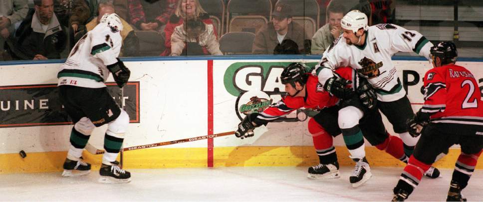 Trent Nelson  |  The Salt Lake Tribune

Kansas City's Jason Cirone tries to get to the puck while Utah's #18- Curtis Sheptak is at left and #12 Mick Vukota is at right in December 1998.