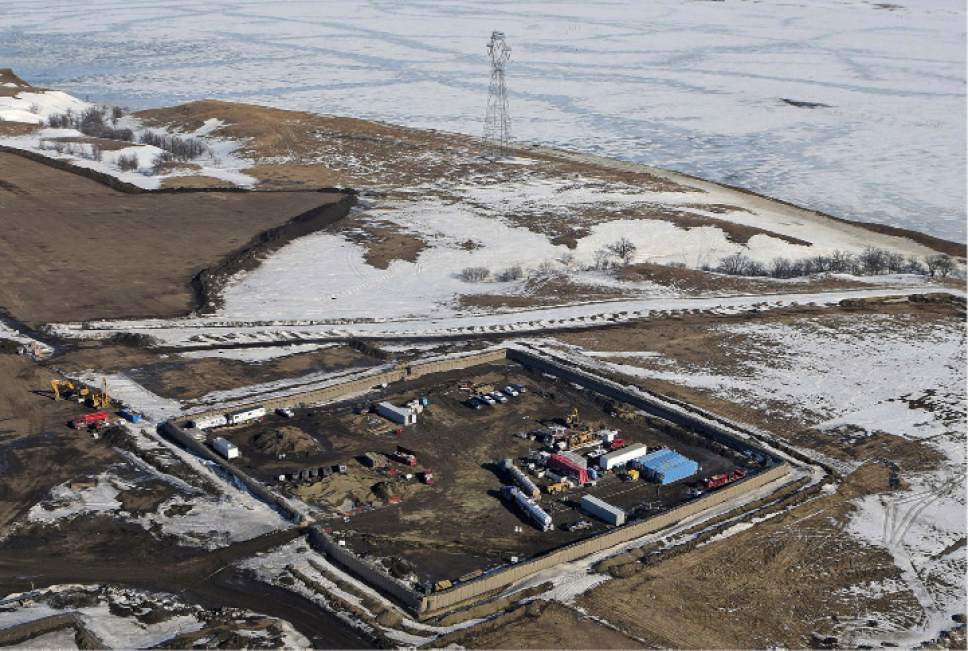 FILE - In this Feb. 13, 2017, aerial file photo shows the site where the final phase of the Dakota Access Pipeline will take place with boring equipment routing the pipeline underground and across Lake Oahe to connect with the existing pipeline in Emmons County near Cannon Ball, N.D. Sioux tribes suing to stop the Dakota Access pipeline want a federal judge to head off the imminent flow of oil. Judge James Boasberg on March 7, 2017, rejected the request of the Standing Rock and Cheyenne River Sioux to stop construction of the final segment of the pipeline that would move oil from North Dakota to Illinois. (Tom Stromme/The Bismarck Tribune via AP, File)