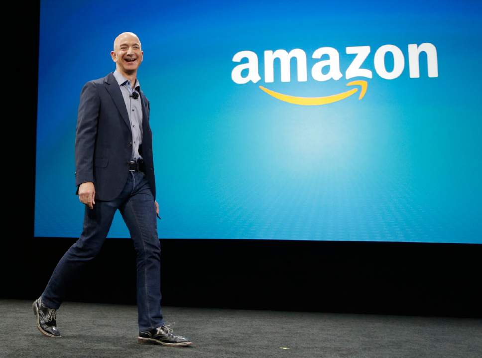 FILE - In this June 18, 2014 file photo, Amazon CEO Jeff Bezos walks on stage for the launch of the new Amazon Fire Phone, in Seattle. Amazon launched on the web twenty years ago on July 16, 1995. (AP Photo/Ted S. Warren, File)
