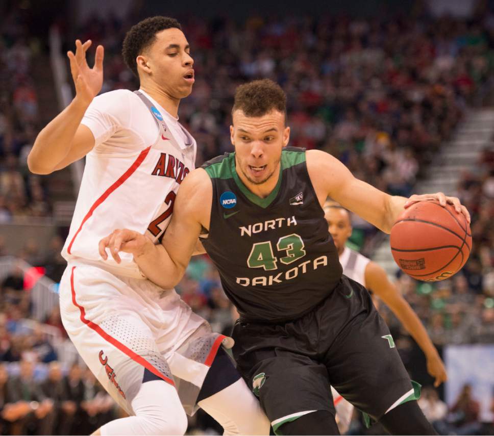 Trent Nelson  |  The Salt Lake Tribune

North Dakota Fighting Sioux forward Drick Bernstine (43) drives past Arizona Wildcats center Chance Comanche (21) during the first round of the NCAA Tournament in Salt Lake City on Thursday, March 16, 2017.