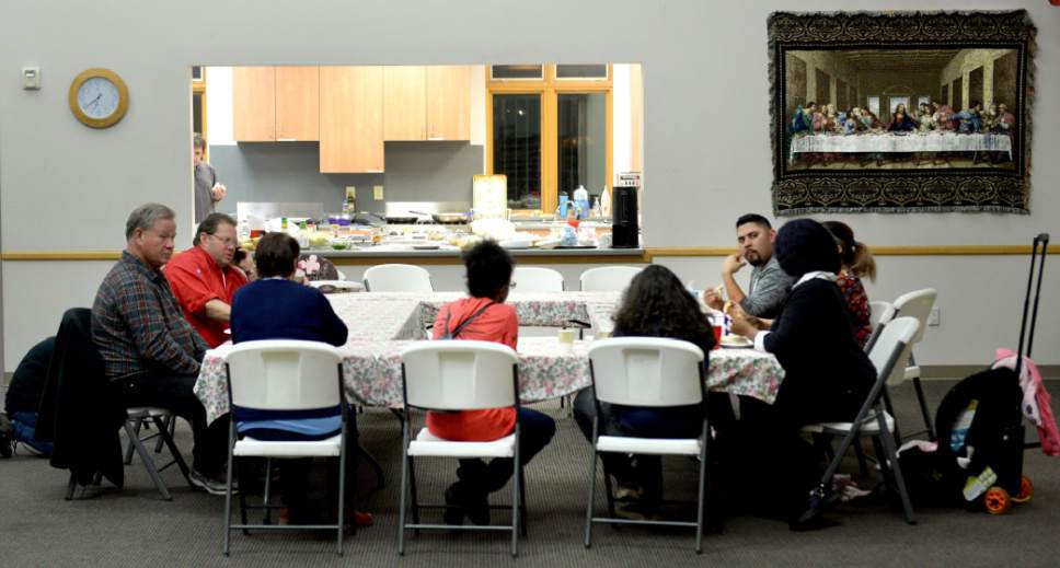 Steve Griffin  |  The Salt Lake Tribune

Stephanie and Javier Tinajero and their two children, Jessica, 11, and Jak, 9, eat dinner with volunteers at Good Shepherd Lutheran Church in Sandy, Utah, Tuesday, Jan. 31, 2017. Many area churches are involved with Family Promise in which various churches house up to homeless families at their meetinghouses for a week. Lots of volunteers help provide the meals and help take care of the residents.
