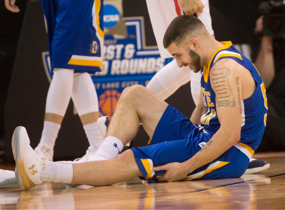 Chris Detrick  |  The Salt Lake Tribune

South Dakota State Jackrabbits guard Michael Orris (50) sits on the floor after hurting his leg during first round of the NCAA Tournament in Salt Lake City on Thursday, March 16, 2017.