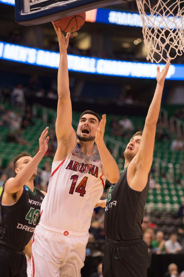 Trent Nelson  |  The Salt Lake Tribune

Arizona Wildcats center Dusan Ristic (14) drives to the hoop past North Dakota Fighting Sioux center Carson Shanks (5) and North Dakota Fighting Sioux forward Drick Bernstine (43) during the first round of the NCAA Tournament in Salt Lake City on Thursday, March 16, 2017.