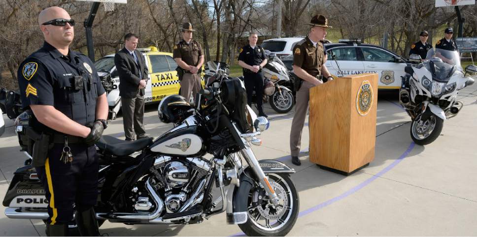Al Hartmann  |  The Salt Lake Tribune
UHP Col. Michael Rapich, center, and police officers from several law enforcement agencies hold a press conference in Sugar House Park Wednesday March 16.  They are teaming up to protect the public from DUI drivers during St. PatrickÌs Day and March Madness festivities.  
ItÌs a big weekend in Salt Lake City  with St. PatrickÌs Day and March Madness.  With all of the special events occurring in Salt Lake City, officers are teaming up to prevent, detect and stop impaired drivers. Two DUI blitzes will be held over the weekend - the Utah Highway Patrol will have one on Friday night and a multi-jurisdictional team of officers will work one in Salt Lake City on Saturday night. More than 150 extra shifts have been given to law enforcement agencies to remove impaired drivers from UtahÌs roadways.