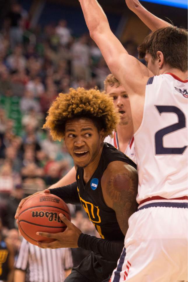 Trent Nelson  |  The Salt Lake Tribune

Virginia Commonwealth Rams forward Justin Tillman (4) looks to pass the ball around St. Mary's Gaels forward Dane Pineau (22) during the first round of the NCAA Tournament in Salt Lake City on Thursday, March 16, 2017.