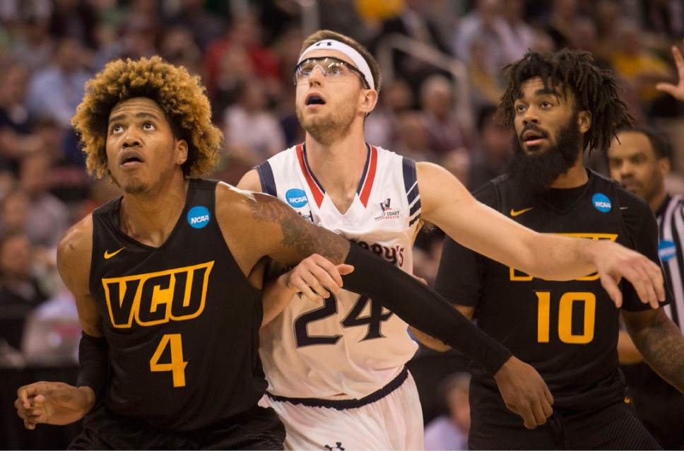 Chris Detrick  |  The Salt Lake Tribune

Virginia Commonwealth Rams forward Justin Tillman (4) and his teammate Jonathan Williams (10) box out St. Mary's Gaels forward Calvin Hermanson (24) during the first round of the NCAA Tournament in Salt Lake City on Thursday, March 16, 2017.