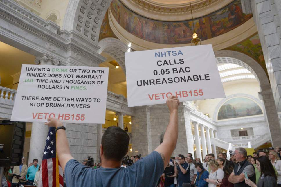 Al Hartmann  |  Tribune file photo
Jerry Fletcher holds signs at a March rally in the state capitol rotunda asking Gov. Herbert to veto a just-passed bill that would lower the blood-alcohol content for drunkenness from 0.08 to 0.05. Most there thought lowering of the levels would be bad for the hospitality industry and tarnish the state's reputation as a welcoming place for tourism and attracting out of state businesses.