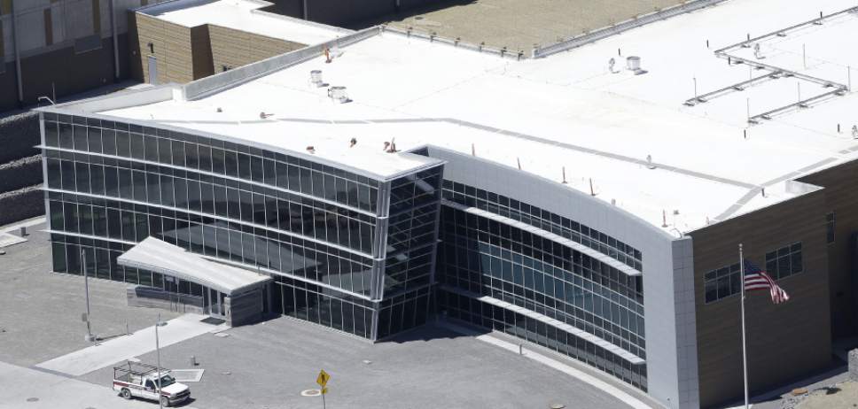 This June 6, 2013, photo, shows an aerial view of the NSA's Utah Data Center in Bluffdale, Utah. The nation's new billion-dollar epicenter for fighting global cyberthreats sits just south of Salt Lake City, tucked away on a National Guard base at the foot of snow-capped mountains. The long, squat buildings span 1.5 million square feet, and are filled with super-powered computers designed to store massive amounts of information gathered secretly from phone calls and emails. (AP Photo/Rick Bowmer)