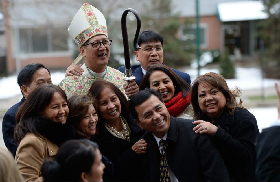 Francisco Kjolseth | The Salt Lake Tribune
Congregation members crowd Bishop Oscar A. Solis as they pose for photographs following the installation ceremony at the Cathedral of the Madeleine on Tuesday, March 7, 2017.