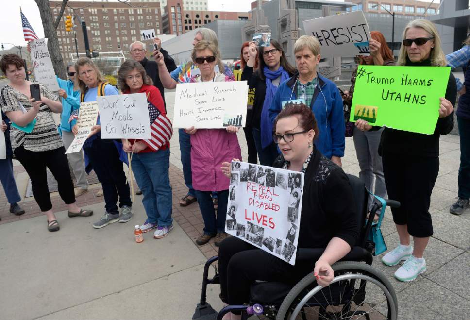 Al Hartmann  |  The Salt Lake Tribune
People gathered in front of the Wallace Bennett Federal Building in Salt Lake City Tuesday March 21  calling on Senators Mike Lee and Orrin Hatch to "stand for Utah values."  Stacy Stanford, with the Healthcare Rights Coalition holds sign of people she knows with disabilities that could be affected by the dismantling of the Affordable Care Act and proposed cuts to social programs under the proposed Trump budget.