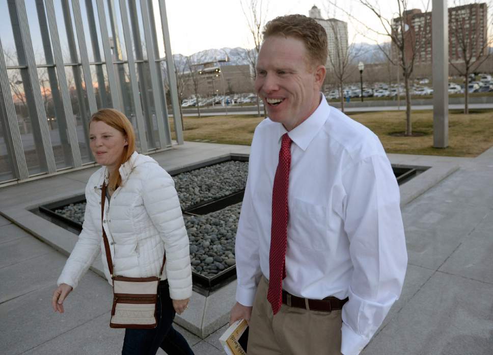 Al Hartmann  |  The Salt Lake Tribune
Jeremy Johnson walks to federal court in  Salt Lake City on Tuesday, March 14, accompanied by his wife, Sharla, and lawyer Mary Coporon.  He was released from the Salt Lake County Jail on Monday and no federal authorities were on hand to take him back into custody. So he spent the night in a hotel and then turned himself back in Tuesday morning.