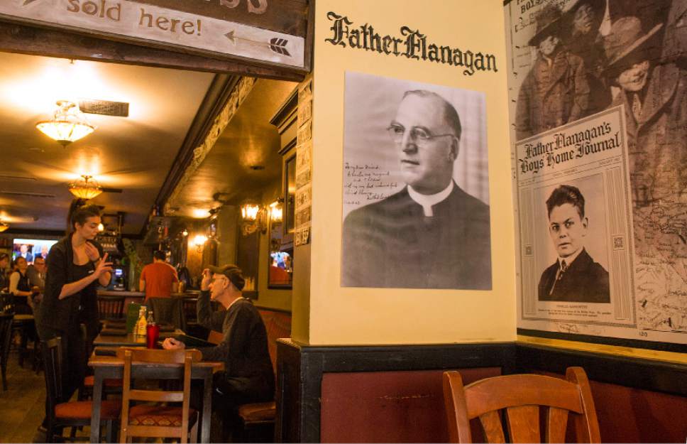 Leah Hogsten  |  The Salt Lake Tribune
Photos of Father Edward .J. Flanagan, from left, and Charles Kenworthy, the grandfather of owner John Kenworthy, adorn the walls of Flanagan's on Main  in Park City. Flanagan and Charles Kenworthy forged a father/son bond after the priest helped pull the homeless boy off the streets.