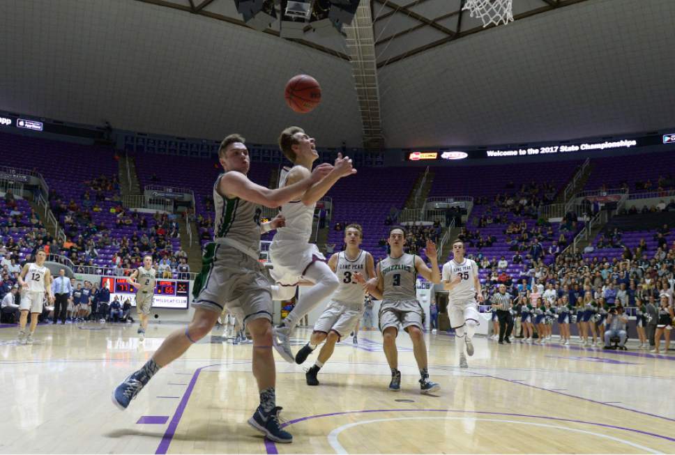 Leah Hogsten  |  The Salt Lake Tribune
Copper Hills guard Stockton Shorts  (12) fouls Lone Peak's Steven Ashworth (3). Lone Peak High School defeated Copper Hills High School 88-73 during their 5A State boys' basketball semifinal playoff game at Weber State University's Dee Events Center, Friday, March 3, 2017.