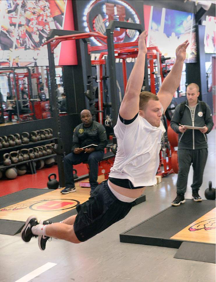 Al Hartmann  |  The Salt Lake Tribune
University of Utah defensive end and NFL Draft hopeful Hunter Dimick launches himself in a standing long jump, one of many measurments and drills to prove to NFL teams that he's ready to fight for a job Thursday March 23.