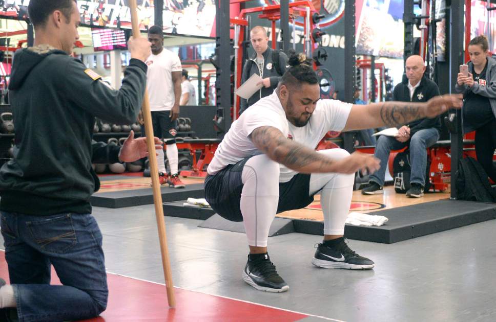 Al Hartmann  |  The Salt Lake Tribune
University of Utah guard and NFL Draft hopeful Isaac Asiata stick sa landing in a standing long jump, one of many measurments and drills to prove to NFL teams that he's ready to fight for a job Thursday March 23.