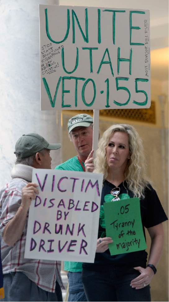 Al Hartmann  |  The Salt Lake Tribune
There were a few counter protestors at a rally in the state capitol rotunda asking Gov. Herbert to veto a just-passed bill that would lower the blood-alcohol content for drunkenness from 0.08 to 0.05.  Most there thought lowering of the levels would be bad for the hospitality industry and tarnish the state's reputation as a welcoming place for tourism and attracting out of state businesses.