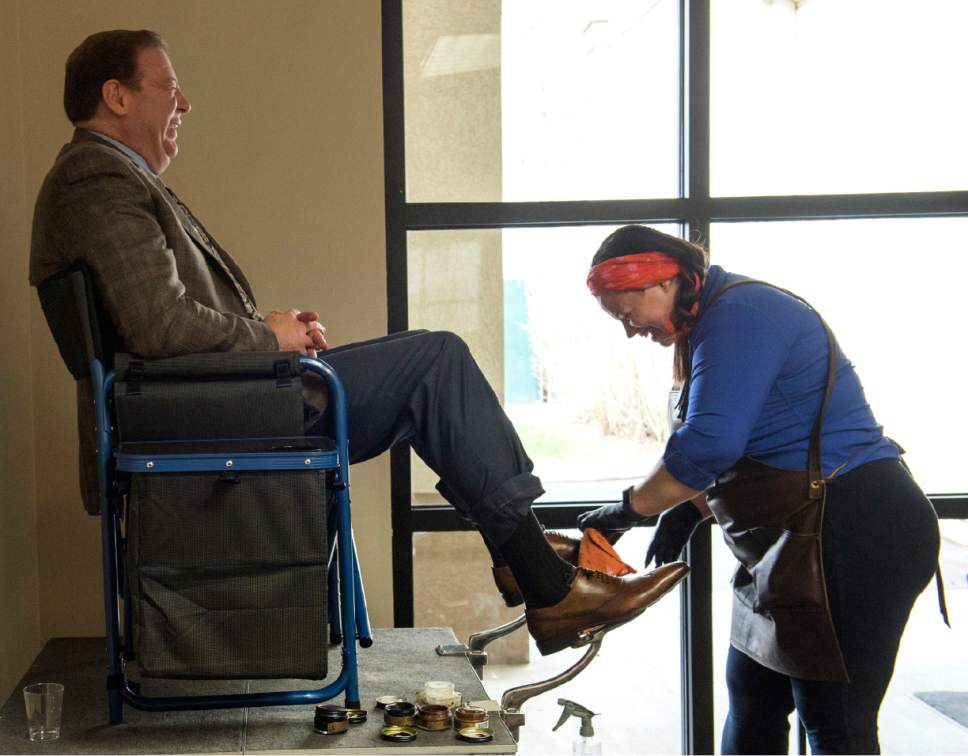 Rick Egan  |  The Salt Lake Tribune
Brad Kofford, gets a shoe shine from Erica Crisco on Wednesday at the opening of The Utah Microenterprise Loan Fund client support center to help the success rate of the small businesses that have received its loans. Crisco has a shoe shine business called Polished.