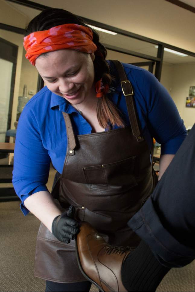 Rick Egan  |  The Salt Lake Tribune

Erica Crisco, shines shoes at the opening of The Utah Microenterprise Loan Fund client support center to help the success rate of the small businesses that have received its loans. Wednesday, March 22, 2017. Crisco has a shoe shine business called Polished.