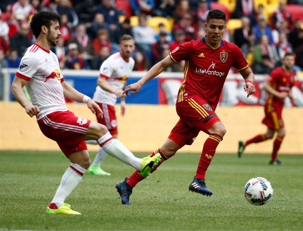 New York Red Bulls midfielder Felipe Martins, left, plays the ball as Real Salt Lake midfielder Luis Silva attacks during the second half of an MLS soccer match, Saturday, March 25, 2017, in Harrison, N.J. The teams tied 0-0. (AP Photo/Julio Cortez)