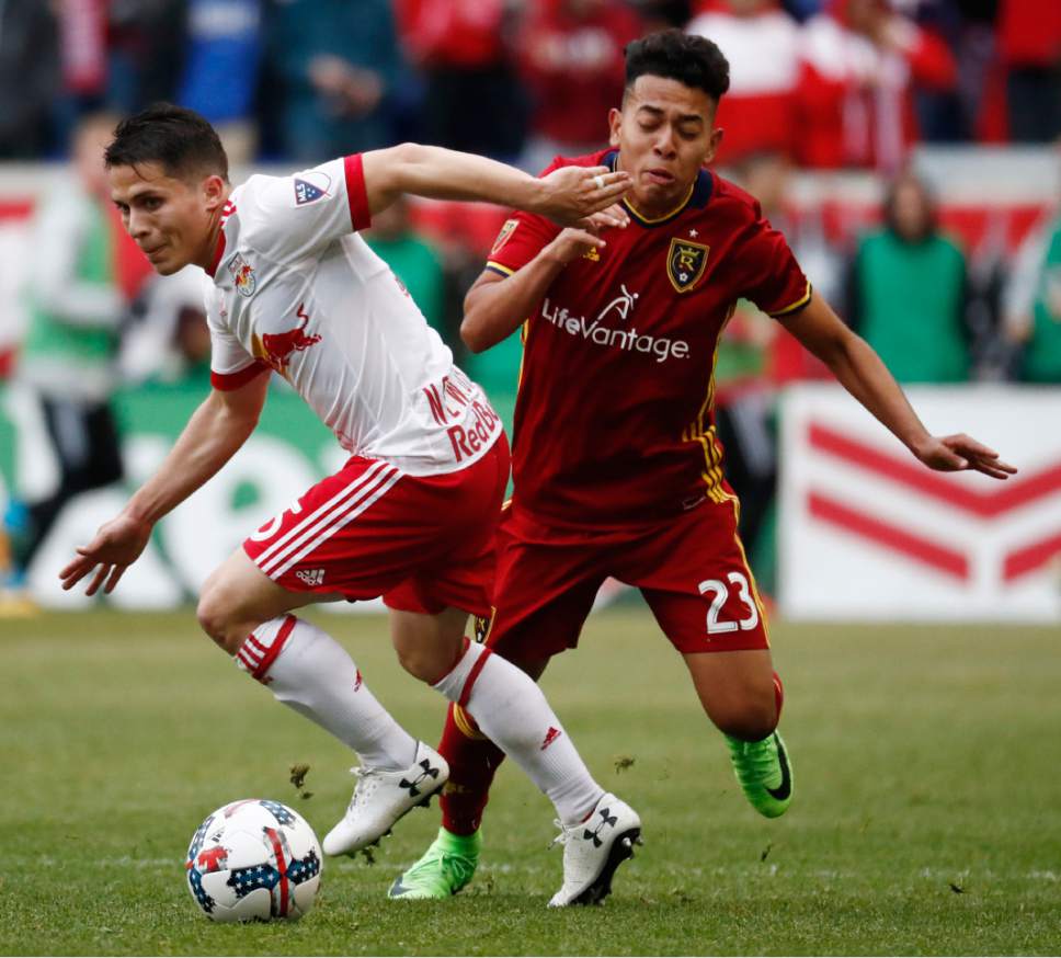 New York Red Bulls defender Connor Lade, left, and Real Salt Lake midfielder Sebastian Saucedo compete for the ball during the second half of an MLS soccer match, Saturday, March 25, 2017, in Harrison, N.J. (AP Photo/Julio Cortez)