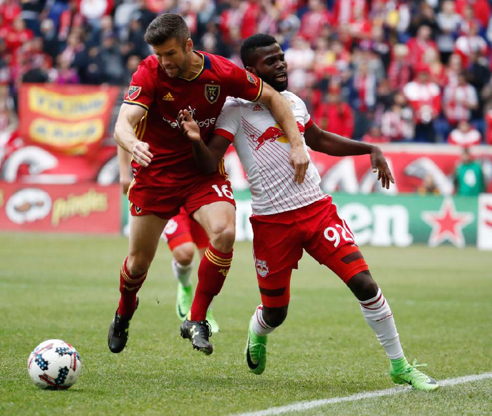 Real Salt Lake defender Chris Wingert, left, and New York Red Bulls defender Kemar Lawrence compete for the ball during the first half of an MLS soccer match, Saturday, March 25, 2017, in Harrison, N.J. (AP Photo/Julio Cortez)