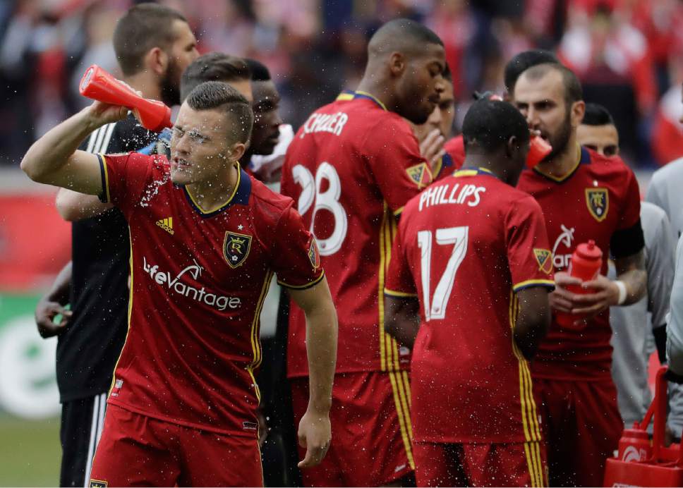 Real Salt Lake forward Brooks Lennon sprays himself with water prior to an MLS soccer match against the New York Red Bulls, Saturday, March 25, 2017, in Harrison, N.J. (AP Photo/Julio Cortez)