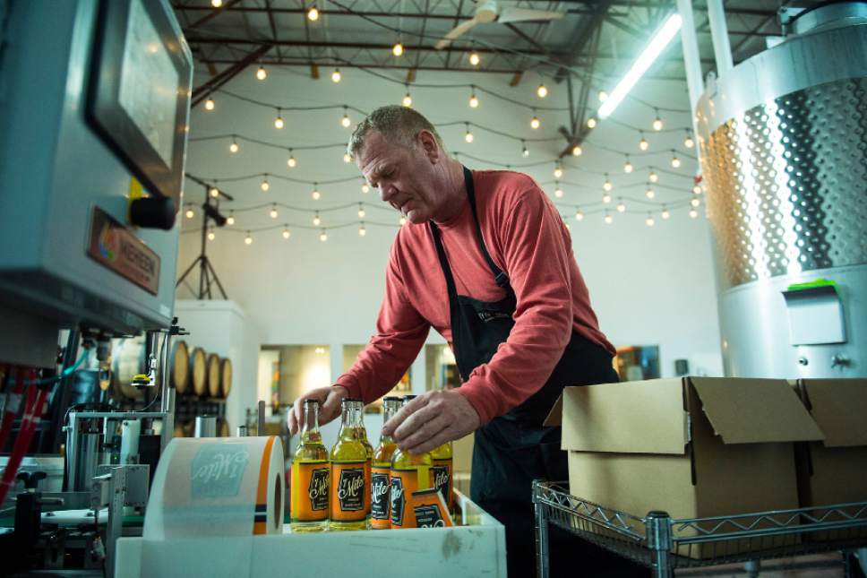 Chris Detrick  |  The Salt Lake Tribune
Cider maker Joel Goodwillie labels bottles of 7 Mile Session Hard Cider at Mountain West Hard Cider on Wednesday, March 22, 2017.