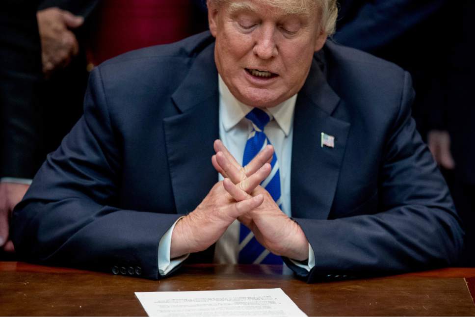 President Donald Trump speaks before signing various bills, Monday, March 27, 2017, in the Roosevelt Room of the White House in Washington. (AP Photo/Andrew Harnik)