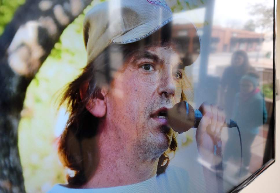 Francisco Kjolseth | The Salt Lake Tribune
People are reflected on a screen as they arrive for an open mic memorial in honor of Kurt Cochran at the Bountiful Davis Arts Center, after he died in the recent terrorist attack in London. He was an active member of Utah's music community and on Sunday, March 26, 2017, musicians from Onion Street Studio and Summerfest gathered to perform in his honor.