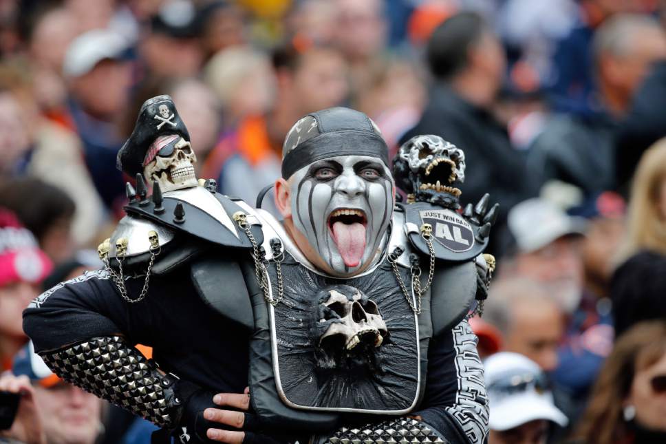 A Oakland Raiders fan dresses up for the game during the first half of an N...