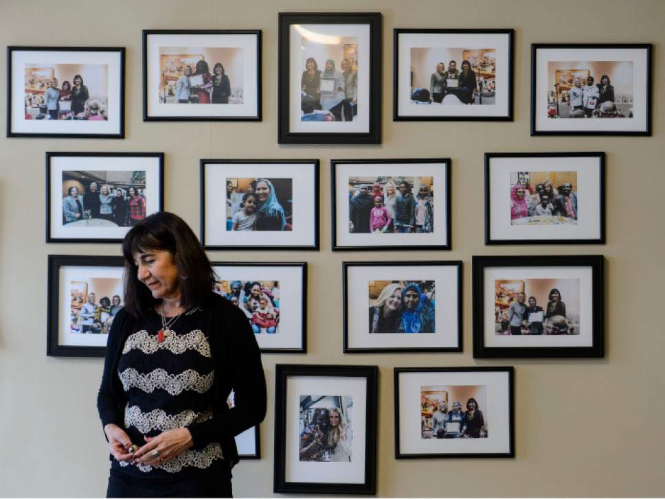 Steve Griffin  |  The Salt Lake Tribune
Women of the World executive director Samira Harnish stands in front of photos of women who she has provided assistance in her non-profit that seeks to help refugees in Salt Lake City.