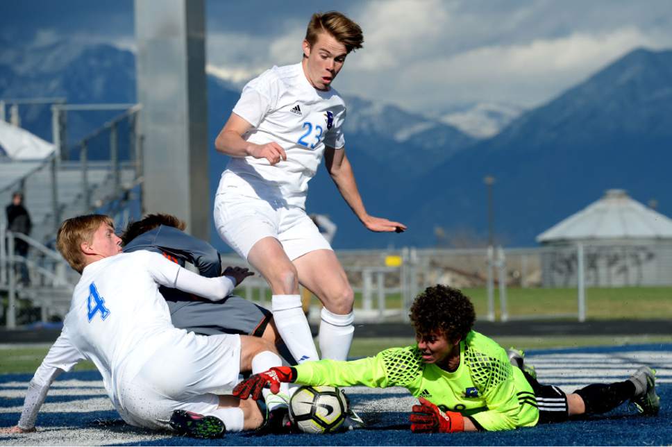 Steve Griffin  |  The Salt Lake Tribune
Bingham goalkeeper Zachary Rothey avoids a collision in front of the goal as he stretches for the ball during game against Brighton at Bingham High School in South Jordan on Tuesday, March 28, 2017.