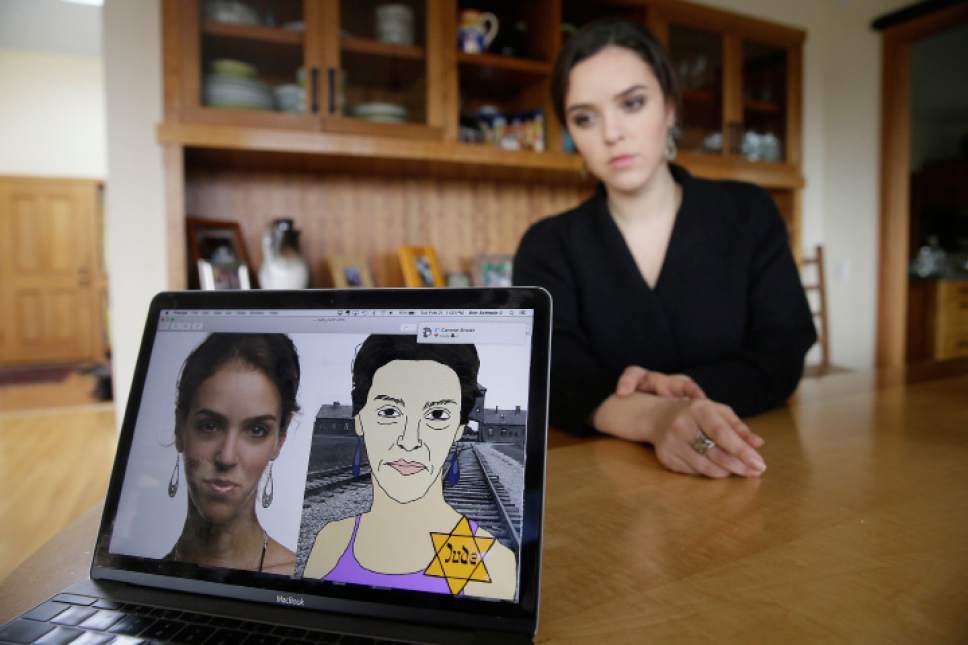 In this Feb. 21, 2017, photo, Erin Schrode poses behind a laptop displaying anti-Semitic images of herself that she received in her email and social media at her home in Mill Valley, Calif. Less than a week before the election for her long-shot congressional campaign, Schrode woke up in her northern California home, rolled over in bed and reflexively checked her cellphone. The 25-year-old activist burst into tears when she found a barrage of anti-Semitic emails. (AP Photo/Eric Risberg)
