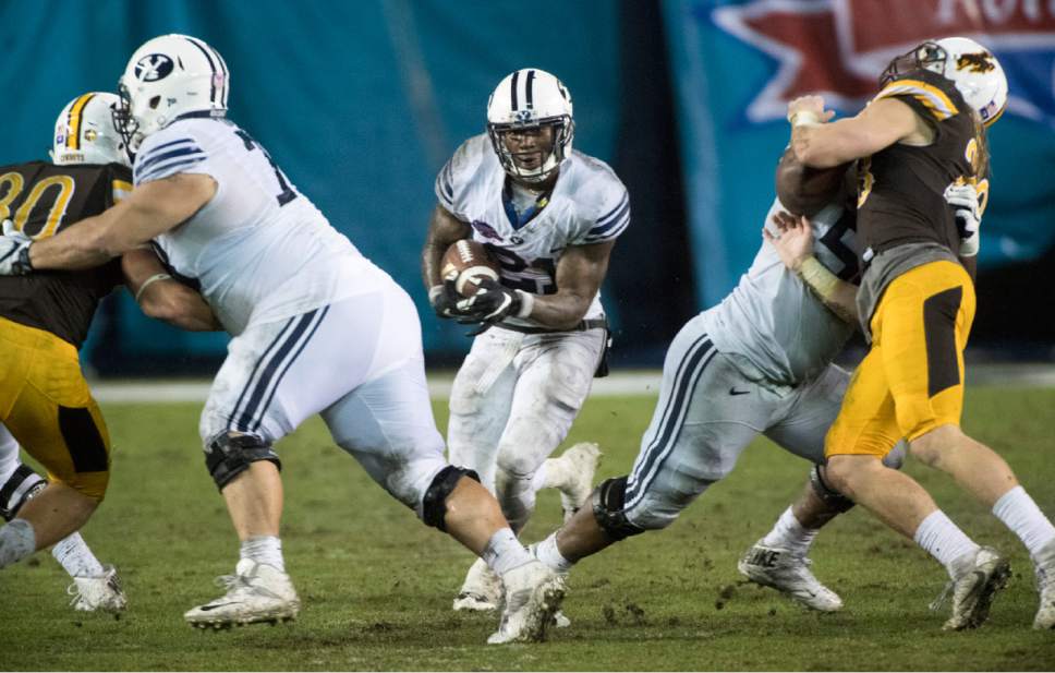 Rick Egan  |  The Salt Lake Tribune

Brigham Young offensive lineman Tuni Kanuch (78) and offensive lineman Tejan Koroma (56) open up a hole for running back Jamaal Williams (21) to run for a 36-yard touchdown for the Cougars, in the Poinsettia Bowl, at Qualcomm Stadium in San Diego, December 21, 2016.