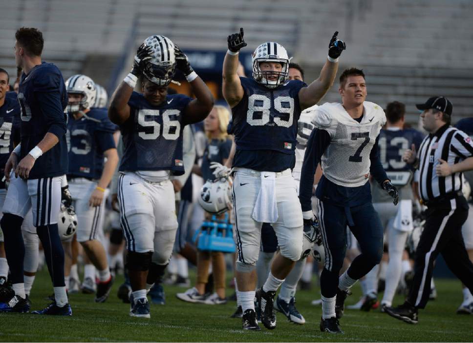 Scott Sommerdorf   |  The Salt Lake Tribune
BYU players Tejan Koroma, 56, Steven Richards, 89, and Michah Hannemann, 7, yelled as the scrimmage ended. BYU football had it's first scrimmage, Friday, March 27, 2015.