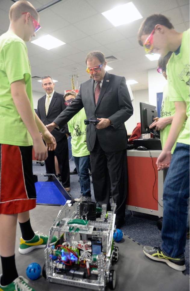 Al Hartmann  |  The Salt Lake Tribune
Gov. Gary Herbert gets schooled by students of the Velocity Raptors, a club of robot specialists at Oquirrh Hills Middle School in Riverton Wednesday March 29 where he signed a series of education bills passed by this year's legislative session. They talked him through how to operate the club's robot.