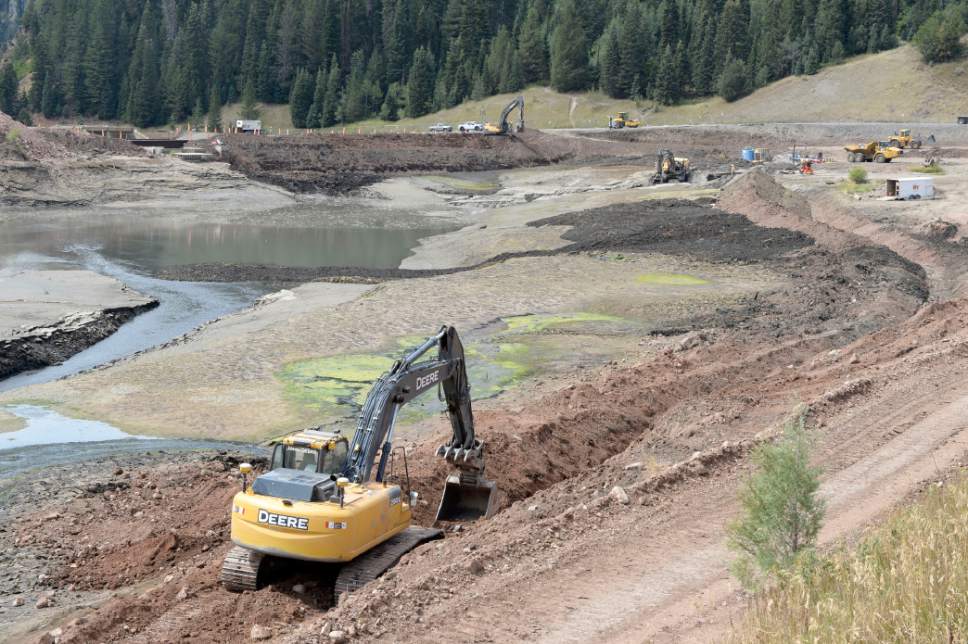 Al Hartmann  |  The Salt Lake Tribune
Backhoe digs a trench around the side of Tibble Fork Reservoir Thursday August  25 . This  will enable the incoming flow of water in the upper part of the reservoir to be diverted allowing crews to remove toxic sediment.