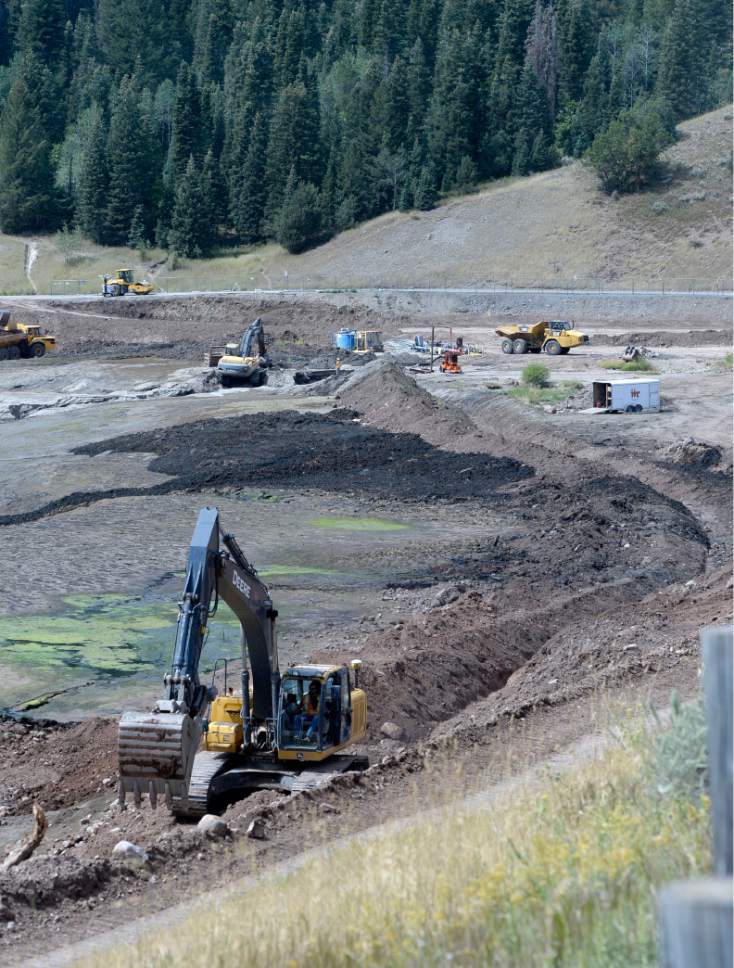Al Hartmann  |  The Salt Lake Tribune
Backhoe digs a trench around the side of Tibble Fork Reservoir Thursday August  25 . This  will enable the incoming flow of water in the upper part of the reservoir to be diverted allowing crews to remove toxic sediment.