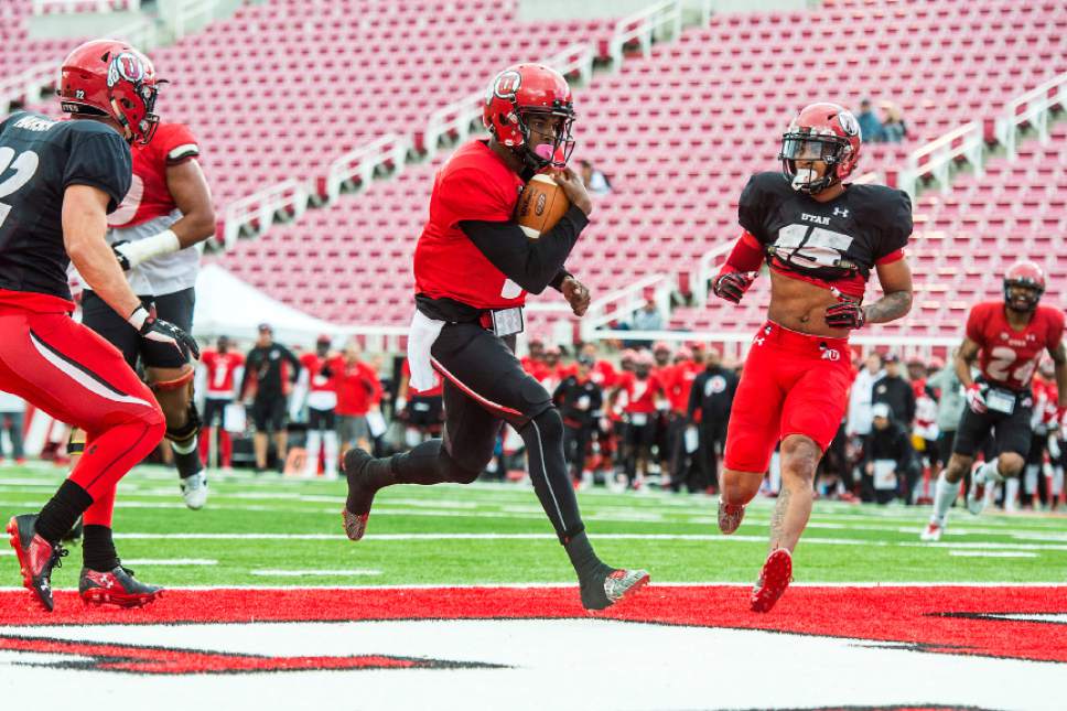 Chris Detrick  |  The Salt Lake Tribune
Utah Utes quarterback Troy Williams (3) runs for a touchdown past Utah Utes defensive back Chase Hansen (22) and Utah Utes defensive back Corrion Ballard (15) during a scrimmage at Rice-Eccles Stadium Friday March 31, 2017.