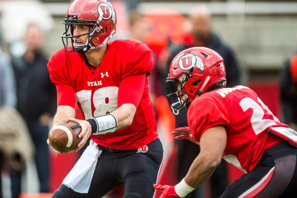 Chris Detrick  |  The Salt Lake Tribune
Utah Utes quaterback Cooper Bateman (18) hands off to Utah Utes Jordan Howard (26) during a scrimmage at Rice-Eccles Stadium Friday March 31, 2017.