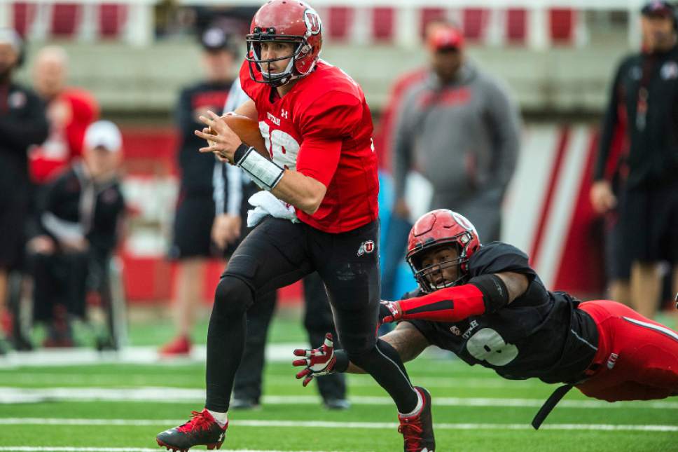 Chris Detrick  |  The Salt Lake Tribune
Utah Utes quaterback Cooper Bateman (18) runs the ball past Utah Utes defensive end Chris Hart (8) during a scrimmage at Rice-Eccles Stadium Friday March 31, 2017.